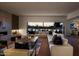 Spacious living room with large windows, fireplace, and sectional sofa at 5525 E Lincoln Dr # 124, Paradise Valley, AZ 85253