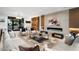 Living room with a fireplace, built-in shelving, and large windows at 5525 E Lincoln Dr # 124, Paradise Valley, AZ 85253