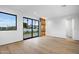 Bedroom with hardwood floors, sliding doors, and backyard view at 5525 E Lincoln Dr # 124, Paradise Valley, AZ 85253