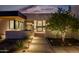 Stunning home exterior with walkway and landscape lighting at night at 5525 E Lincoln Dr # 124, Paradise Valley, AZ 85253