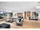 Spacious living room with large sectional sofa, wood floors, and modern decor at 5525 E Lincoln Dr # 124, Paradise Valley, AZ 85253