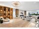 Bright living room featuring hardwood floors, a fireplace, and built-in shelving at 5525 E Lincoln Dr # 124, Paradise Valley, AZ 85253