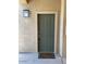 Inviting condo entry with a green door and welcome mat at 16013 S Desert Foothills Pkwy # 1101, Phoenix, AZ 85048