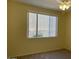 Spacious bedroom with large window and ceiling fan at 16013 S Desert Foothills Pkwy # 1101, Phoenix, AZ 85048