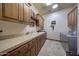 Laundry room with ample storage and built-in cabinets at 38800 N 107Th Way, Scottsdale, AZ 85262