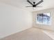 Spacious bedroom with ceiling fan, large window, and neutral carpeting at 839 S Westwood -- # 182, Mesa, AZ 85210
