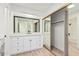 Updated bathroom with white vanity, large mirror, and walk-in closet at 839 S Westwood -- # 182, Mesa, AZ 85210