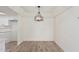 Simple dining area with hardwood floors and a modern light fixture at 839 S Westwood -- # 182, Mesa, AZ 85210