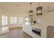 Modern kitchen with white cabinetry, marble countertops, and a built-in oven at 19832 N 95Th Ave, Peoria, AZ 85382