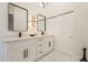 Elegant bathroom with dual sinks, white cabinets, and marble countertops at 19832 N 95Th Ave, Peoria, AZ 85382