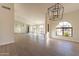 Spacious dining area with arched windows and a modern chandelier at 19832 N 95Th Ave, Peoria, AZ 85382