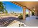 Covered patio overlooking a golf course and lush landscaping at 19832 N 95Th Ave, Peoria, AZ 85382