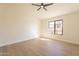 Well-lit bedroom featuring wood-look floors and a large window at 19832 N 95Th Ave, Peoria, AZ 85382