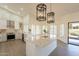 Bright kitchen, features white cabinets, marble island, and high-end appliances at 19832 N 95Th Ave, Peoria, AZ 85382