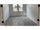 Well-lit bedroom with wood-look tile flooring at 16092 W Questa Dr, Surprise, AZ 85387
