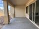 Covered patio with concrete flooring and access to the backyard at 16092 W Questa Dr, Surprise, AZ 85387