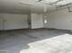 Spacious two-car garage with ample storage space and epoxy flooring at 16092 W Questa Dr, Surprise, AZ 85387