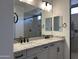 Double vanity bathroom with granite countertops and modern fixtures at 16092 W Questa Dr, Surprise, AZ 85387