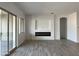 Living room with fireplace, built-in shelving and sliding glass doors at 16092 W Questa Dr, Surprise, AZ 85387