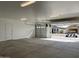 Bright garage with open door, view of neighborhood, and room for two cars at 16092 W Questa Dr, Surprise, AZ 85387
