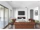 Living room with fireplace, built-in shelving and sliding glass doors at 16092 W Questa Dr, Surprise, AZ 85387