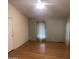 Bedroom with hardwood floors and window with sheer curtains at 11596 W Sierra Dawn Blvd # 382, Surprise, AZ 85378