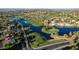 Aerial view of a luxury golf course community with a lake at 1322 W Indigo Dr, Chandler, AZ 85248
