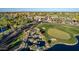 Aerial view of a golf course with a clubhouse and water features at 1322 W Indigo Dr, Chandler, AZ 85248