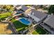 Aerial view of a home with a large backyard, pool, and lush landscaping at 1322 W Indigo Dr, Chandler, AZ 85248