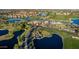 Aerial view of a golf course clubhouse and surrounding landscape at 1322 W Indigo Dr, Chandler, AZ 85248