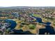Aerial view of homes surrounding a lake and golf course at 1322 W Indigo Dr, Chandler, AZ 85248