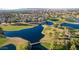 Aerial view of a luxury community with a golf course and lake at 1322 W Indigo Dr, Chandler, AZ 85248