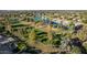 Aerial view of a golf course community with a lake and mature trees at 1322 W Indigo Dr, Chandler, AZ 85248