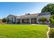 Spacious backyard with a view of the house and lush landscaping at 1322 W Indigo Dr, Chandler, AZ 85248