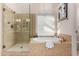 Bathroom with a glass shower and a soaking tub at 1322 W Indigo Dr, Chandler, AZ 85248