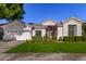 Single-story home with a well-kept lawn and landscaping at 1322 W Indigo Dr, Chandler, AZ 85248