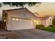 Two car garage with automatic door opener and landscaping at 1322 W Indigo Dr, Chandler, AZ 85248