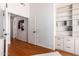 Light and bright hallway with hardwood floors and built-in shelving at 1322 W Indigo Dr, Chandler, AZ 85248