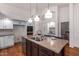 Bright kitchen with double oven, granite island, and hardwood floors at 1322 W Indigo Dr, Chandler, AZ 85248