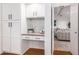 Built-in kitchen nook with granite countertop and white cabinets at 1322 W Indigo Dr, Chandler, AZ 85248