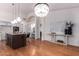 Open concept kitchen with island, hardwood floors, and modern chandelier at 1322 W Indigo Dr, Chandler, AZ 85248