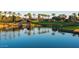 Peaceful lakefront view with palm trees and a waterfall at 1322 W Indigo Dr, Chandler, AZ 85248