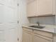 Laundry room with cabinets and utility sink at 1322 W Indigo Dr, Chandler, AZ 85248