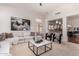 Open living room with kitchen view, comfortable seating and large art at 1322 W Indigo Dr, Chandler, AZ 85248