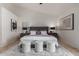 Main bedroom with high ceilings, plush bed, and hardwood flooring at 1322 W Indigo Dr, Chandler, AZ 85248