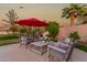 Spacious patio with seating area and red umbrella at 1322 W Indigo Dr, Chandler, AZ 85248
