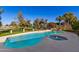 Inviting kidney-shaped pool with spa and landscaping at 1322 W Indigo Dr, Chandler, AZ 85248