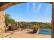 Stunning backyard with a pool, patio furniture, and panoramic mountain views at 42383 N 111Th Pl, Scottsdale, AZ 85262