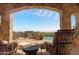 Covered patio overlooks a sparkling pool and scenic mountain views at 42383 N 111Th Pl, Scottsdale, AZ 85262