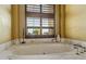 Relaxing bathroom with a freestanding oval bathtub and marble surround at 42383 N 111Th Pl, Scottsdale, AZ 85262
